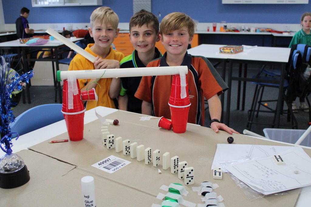 3 young boys building their reaction contraption