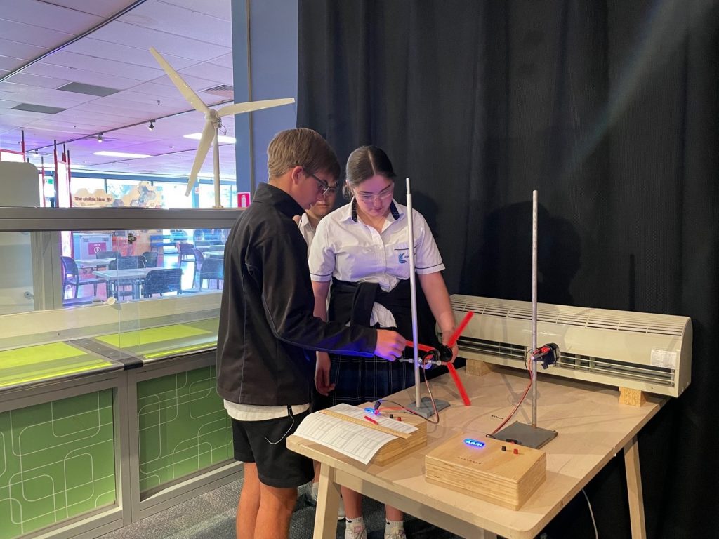 two students playing with a motorised propella